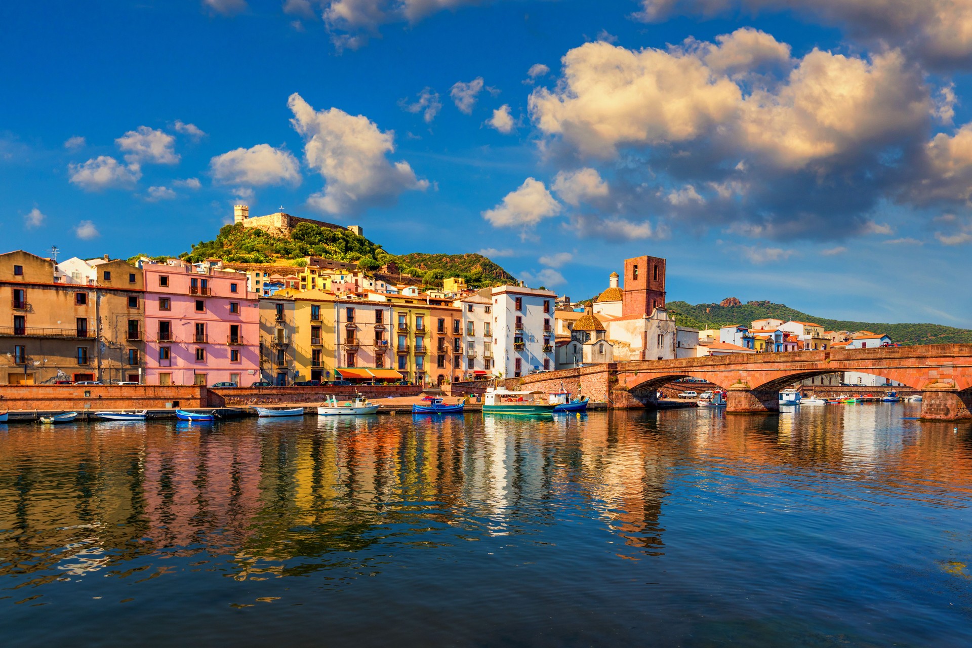 Aerial view of the beautiful village of Bosa with colored houses and a medieval castle. Bosa is located in the north-wesh of Sardinia, Italy. Aerial view of colorful houses in Bosa village, Sardegna.